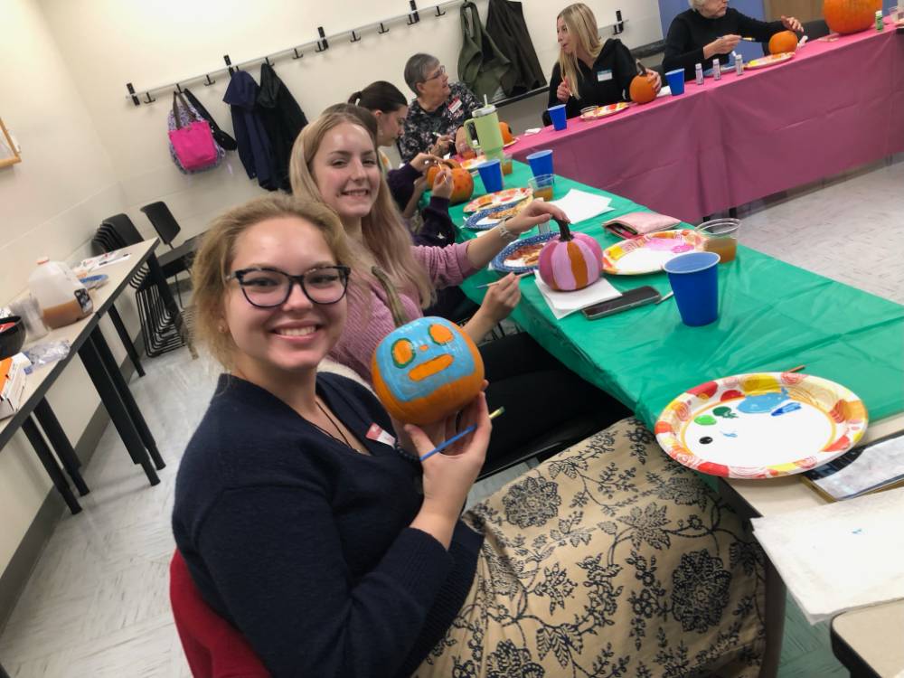 student showing their pumpkins